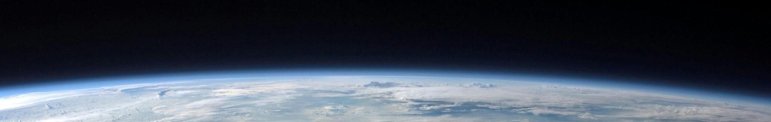 A stunning aerial view of Earth with a massive swirling hurricane, highlighting meteorological beauty.